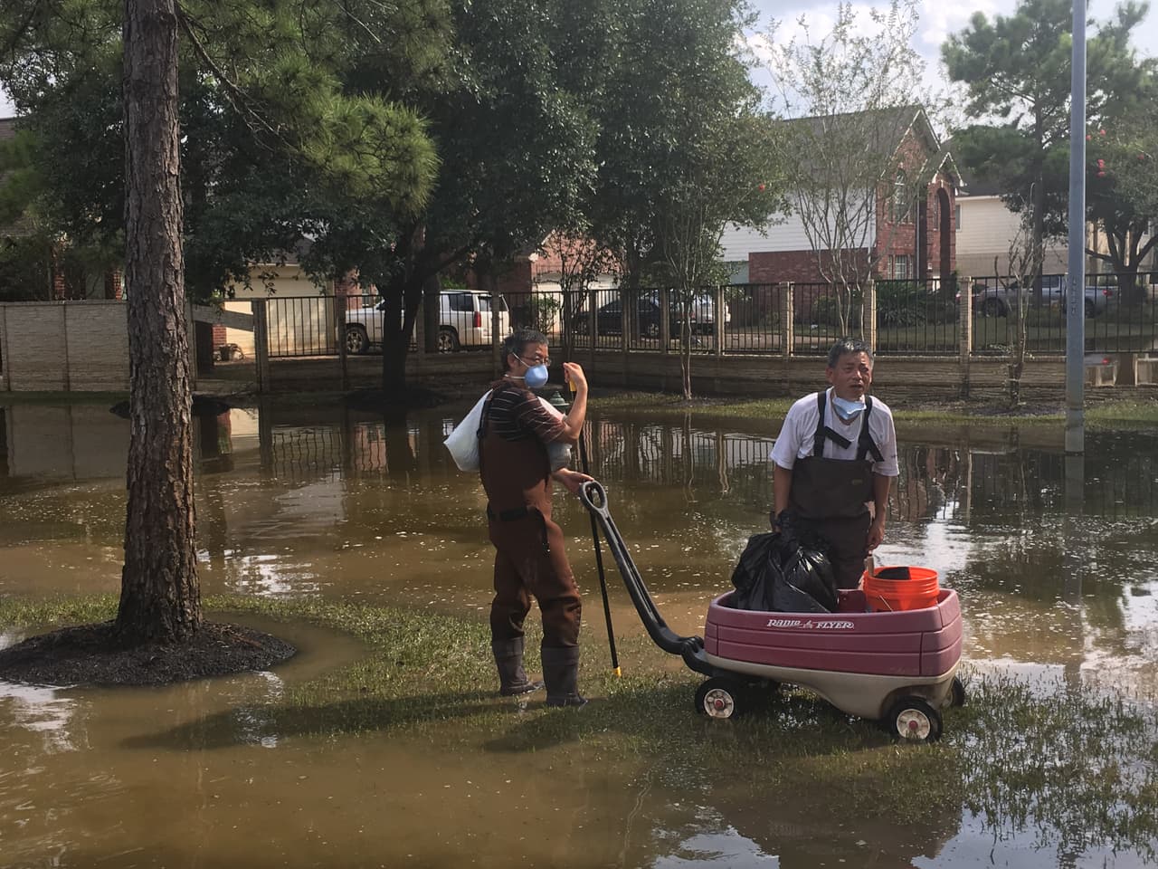 Estos residentes de Canyon Gate se quedaron atrapados en un punto donde el nivel del agua era muy alto y no les permitía avanzar con su carrito cargado con algunas de las pertenencias que rescataron.