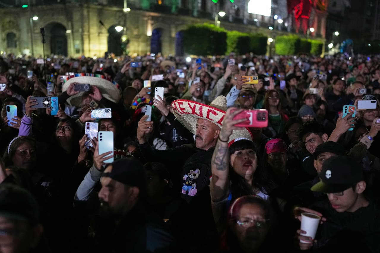 Asistentes captan con sus celulares la ceremonia del Grito de Independencia encabezada por Claudia Sheinbaum desde el Zócalo de Ciudad de México.