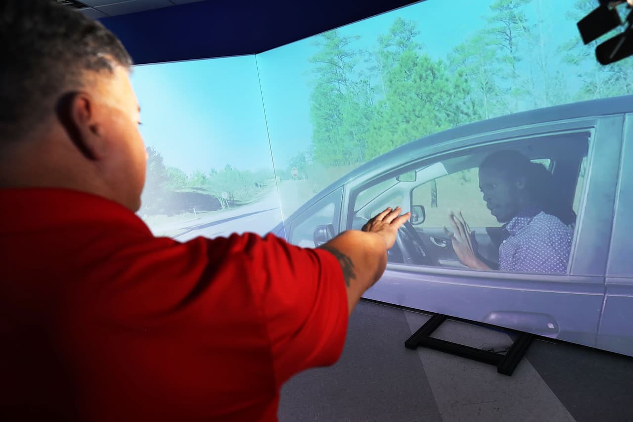 El entrenador de la policía de Miami, Luis Gonzalez, interactua con un potencial criminal virtual antes de sacar su arma de reglamento. “Los entrenadores verán si el oficial tiene alguna deficiencia, para así enfocar donde debe mejorar", agregó Fallat.