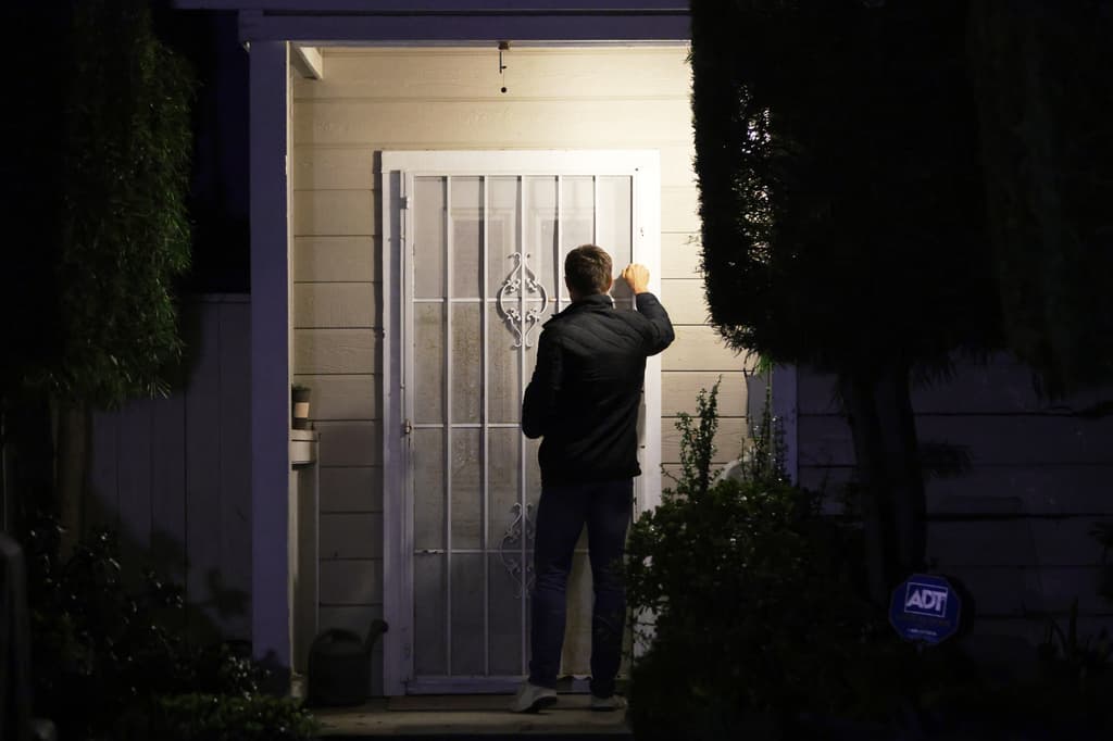 Periodistas tocan la puerta de una casa en una dirección conectada con Allen en Torrance, California.