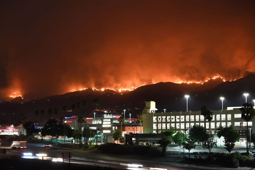 The La Tuna Canyon fire burns in the hills above Burbank, California, early September 2, 2017. The brush fire which quickly burned 2,000 acres started on September 1 and was being driven by heat wave temperatures and high winds. / AFP PHOTO / Robyn Beck (Photo credit should read ROBYN BECK/AFP/Getty Images)