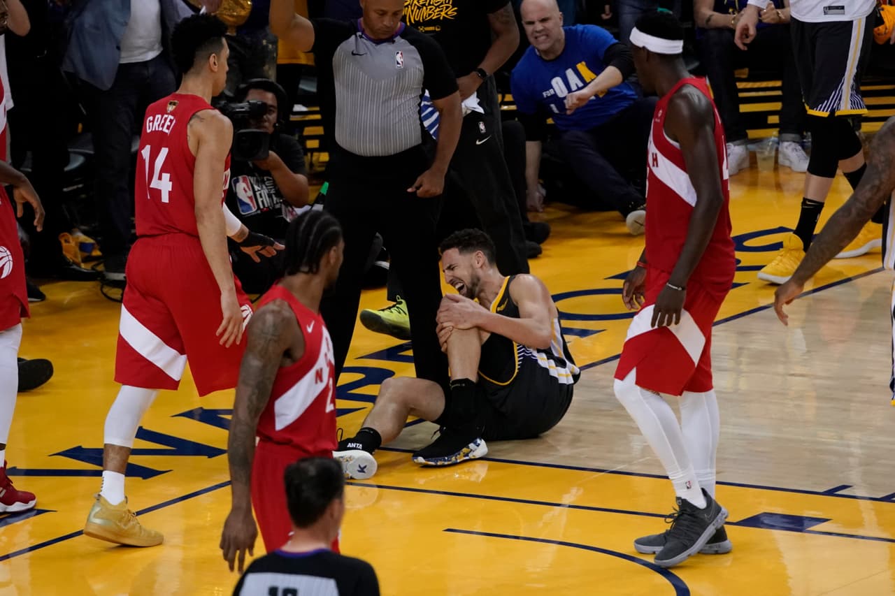 Golden State Warriors guard Klay Thompson reacts after being injured during the second half of Game 6 of basketball's NBA Finals against the Toronto Raptors in Oakland, Calif., Thursday, June 13, 2019.
