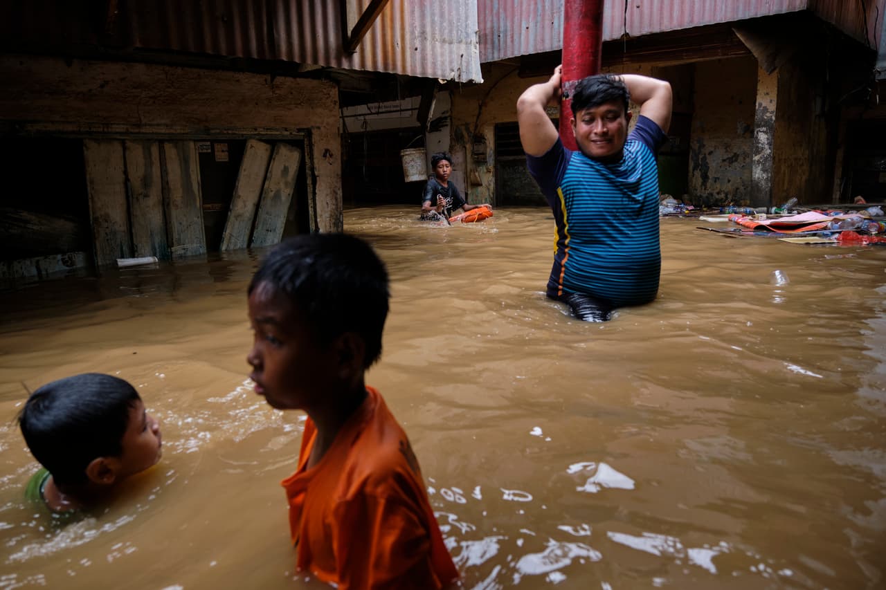 Niños nadan en el agua que cubrió las calles de su vecindario en Yakarta. Cerca de esa región capitalina
<b>murió un niño de ocho años en un alud de tierra y un hombre de 82 años</b>, informó AFP. Otras personas fallecieron ahogadas o por hipotermia y un niño de 16 años resultó electrocutado por una línea eléctrica.