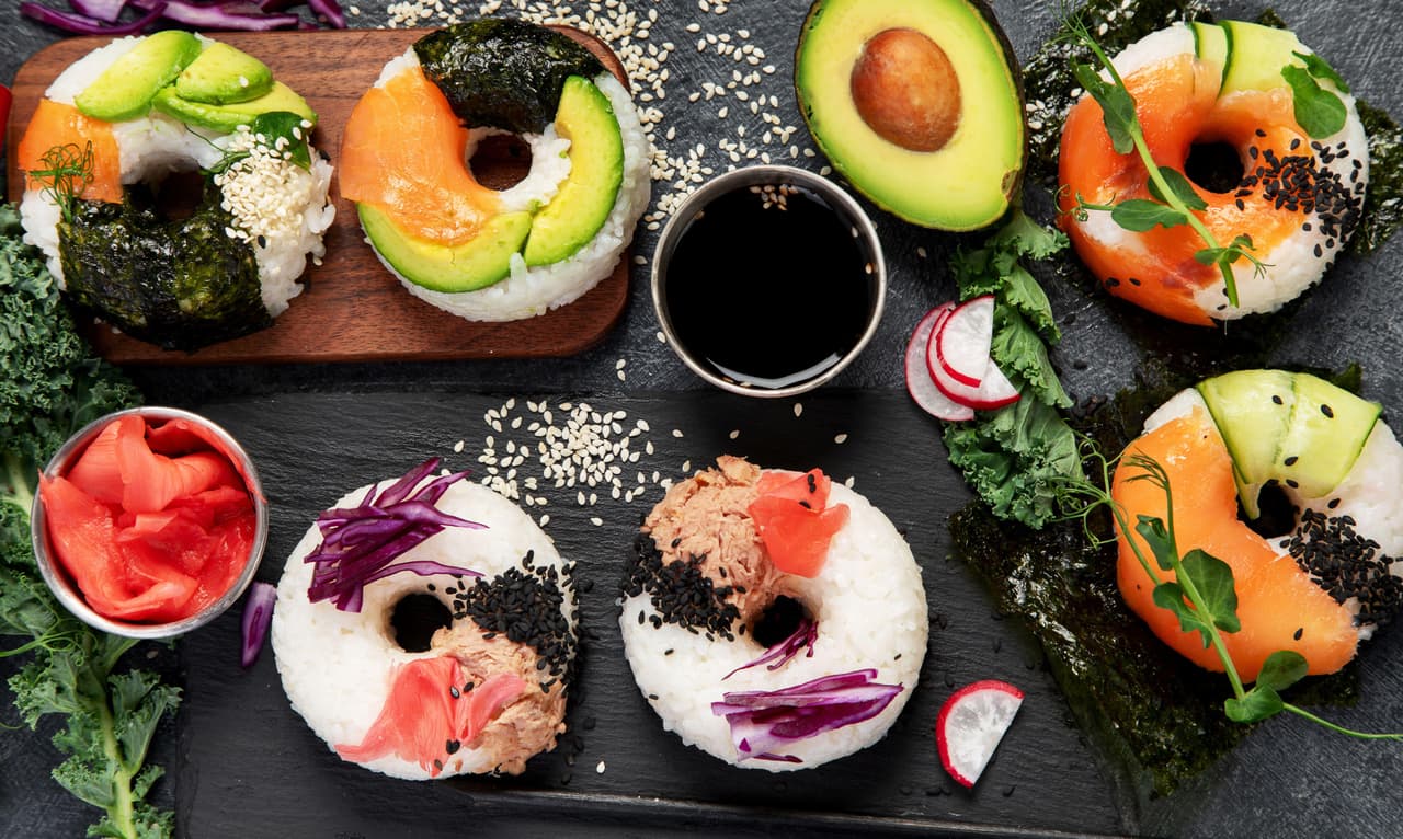 Sushi donuts on a dark background. Hybrid trend food. Top view