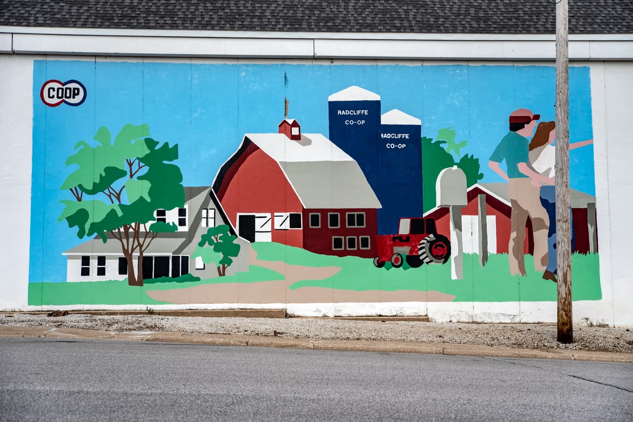 In Radcliffe, Iowa, a mural just north of the farmers' cooperative shows a man and woman in front of an idyllic farm. The current reality is that some of these small cities are fading away.