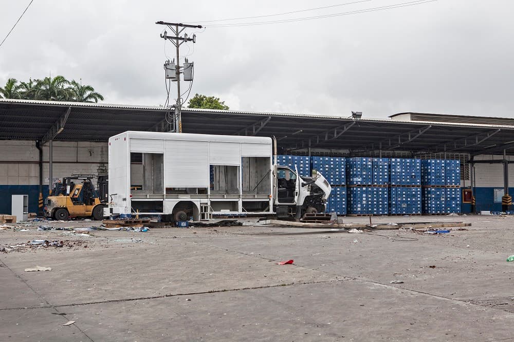 En esta planta de almacenamiento, los camiones y los tractores fueron desvalijados casi por completo. Los ladrones se llevaron desde los motores hasta las ruedas. En algunos casos hasta las puertas de los vehículos. En el suelo de este estacionamiento, había cientos de botellas de cerveza rotas, facturas usadas y nuevas, junto a publicidad destruida de la empresa. Una de sus paredes externas muestra la mancha de un incendio.