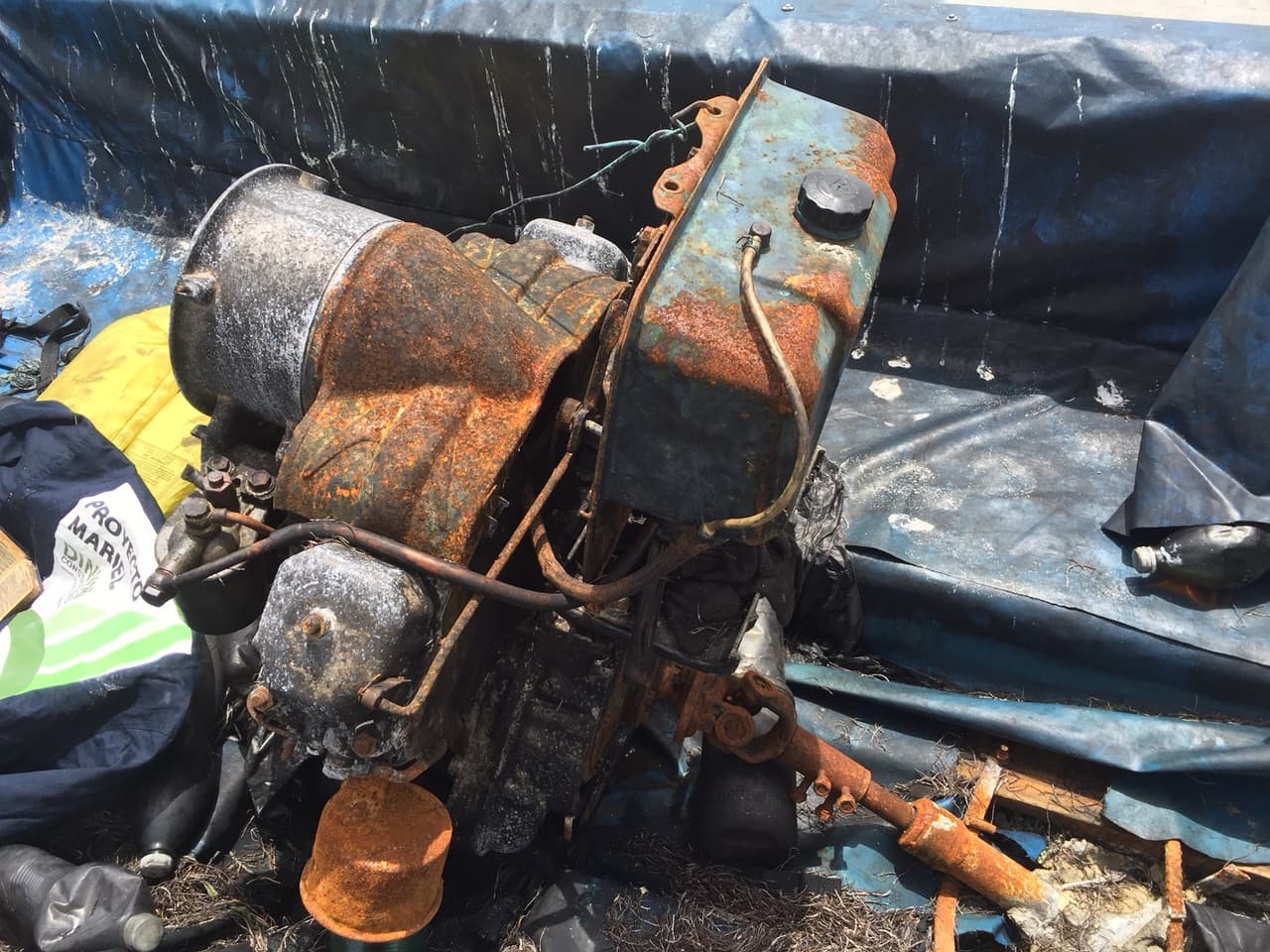 The rusty tractor engine was adapted to power this homemade Cuban raft. The driveshaft is attached to a propeller under the boat, sealed with poured concrete