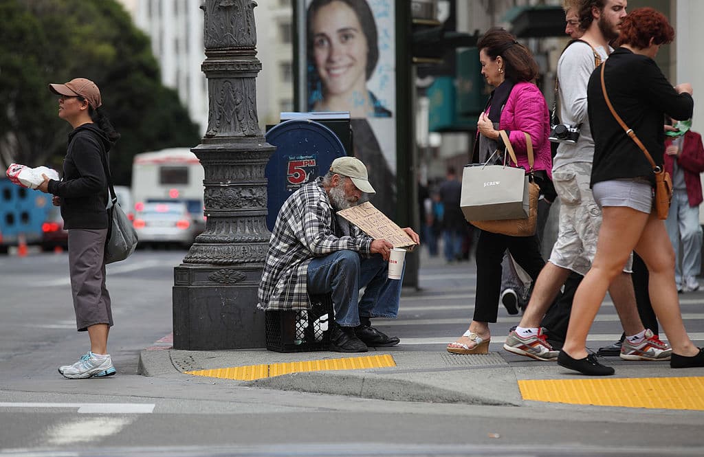 SAN FRANCISCO - SEPTEMBER 16: A homeless man holds a sign as he panhandles for spare change on September 16, 2010 in San Francisco, California. The U.S. poverty rate increased to a 14.3 percent in 2009, the highest level since 1994. (Photo by Justin Sullivan/Getty Images)