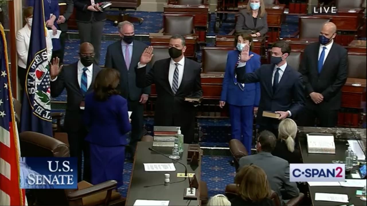 Los senadores Alex Padilla (centro) de California y Rafael Warnock (izquierda) y Jon Ossoff de Georgia levantan sus manos para juramentar sus cargos el 20 de enero de 2021.