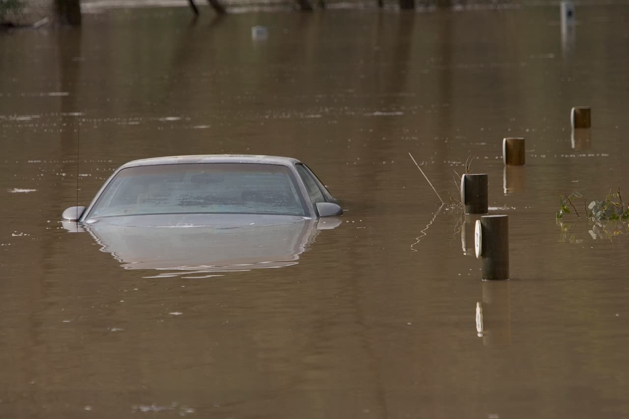 GUERNEVILLE, CA - JANUARY 2: A car located at the River Bend Trailer Park sit in the water from a flood on January 2, 2006 in Guerneville, California. Northern California has been inundated by heavy rain over the past week, causing mudslides and rivers to spill over their banks. (Photo by David Paul Morris/Getty Images)