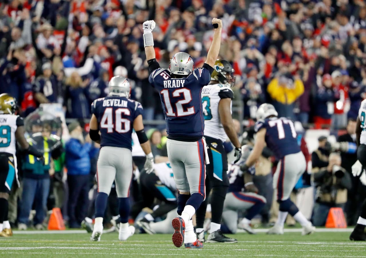 New England Patriots quarterback Tom Brady (12) celebrates a catch by wide receiver Phillip Dorsett during the second half of the AFC championship NFL football game against the Jacksonville Jaguars, Sunday, Jan. 21, 2018, in Foxborough, Mass. (AP Photo/Winslow Townson)