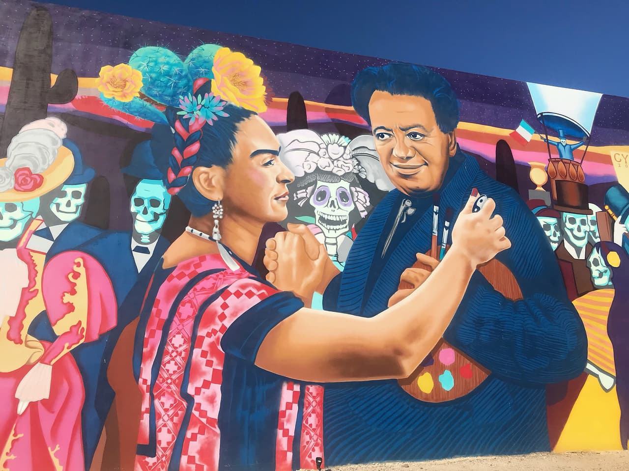 El mural “
<i>Dia de lo Muertos</i>” se encuentra en el
<a href="https://goo.gl/maps/CQMY8TPnNVnjLADL9" target="_blank">895 Calle de los Higos.</a>
<br>
<br>Artista: Rock “CyFi” Martínez