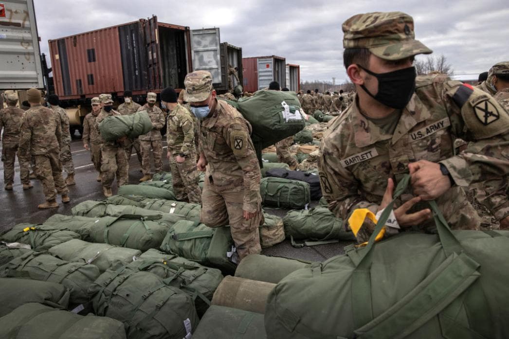 US Army soldiers collect their bags as they arrive at Fort Drum, N.Y., at the end of their deployment to Afghanistan in December 2020.