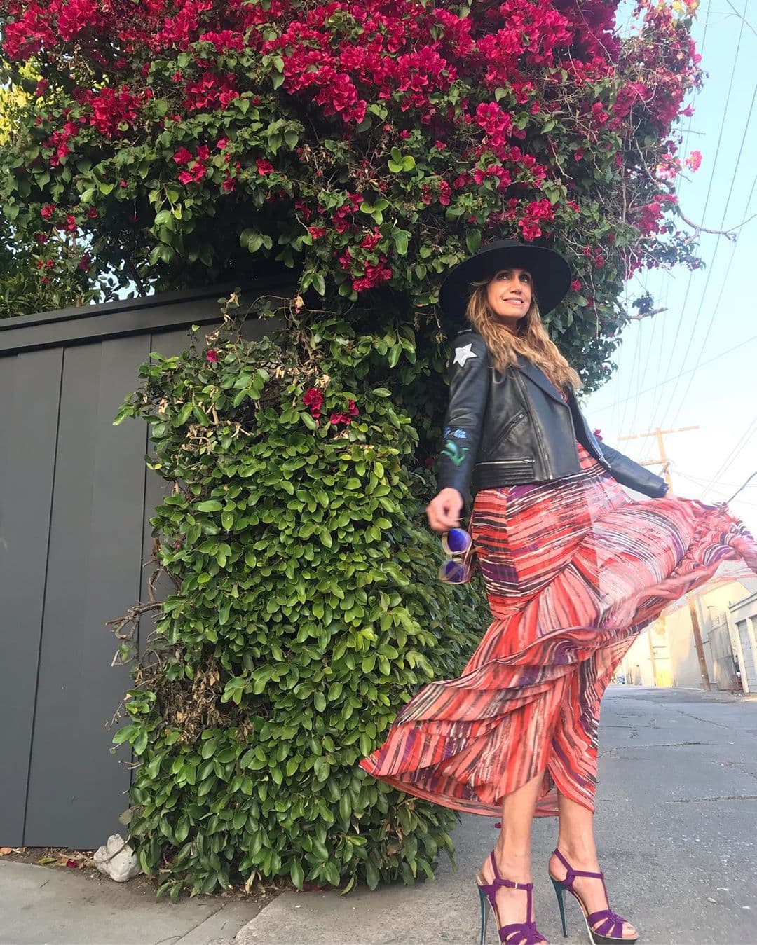 Lució un vestido casual que combinó con zapatos morados, chamarra de piel negra y sombrero.