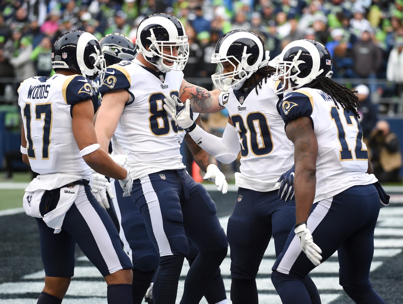 SEATTLE, WA - DECEMBER 17: Running back Todd Gurley #30 of the Los Angeles Rams is greeted by teammates, including Robert Woods #17, Tyler Higbee #89 and Sammy Watkins #12 after scoring a 1 yard touchdown during the first quarter of the game against the Seattle Seahawks at CenturyLink Field on December 17, 2017 in Seattle, Washington. (Photo by Steve Dykes/Getty Images)