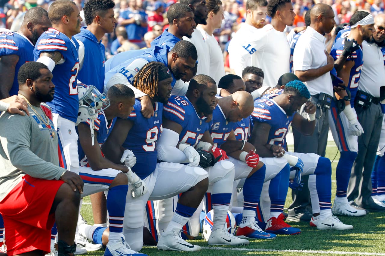 Buffalo Bills players take a knee during the playing of the national anthem prior to an NFL football game against the Denver Broncos, Sunday, Sept. 24, 2017, in Orchard Park, N.Y. (AP Photo/Jeffrey T. Barnes)