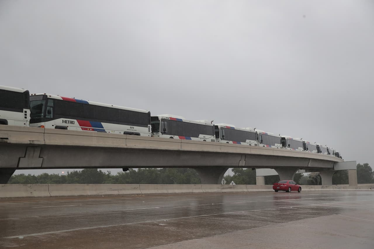 HOUSTON, TX - AUGUST 28: Busses sit on a highway overpass to keep them away from flooding on August 28, 2017 in Houston, Texas. Hurricane Harvey, which made landfall north of Corpus Christi late Friday evening, is expected to dump upwards to 40 inches of rain in areas of Texas causing widespread flooding over the next couple of days. (Photo by Scott Olson/Getty Images)