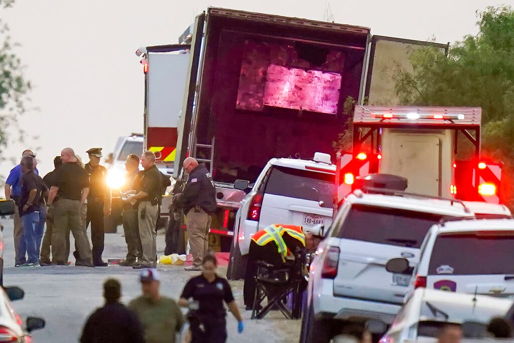 Police and other first responders work the scene where officials say dozens of people have been found dead and multiple others were taken to hospitals with heat-related illnesses after a semitrailer containing suspected migrants was found, Monday, June 27, 2022, in San Antonio.