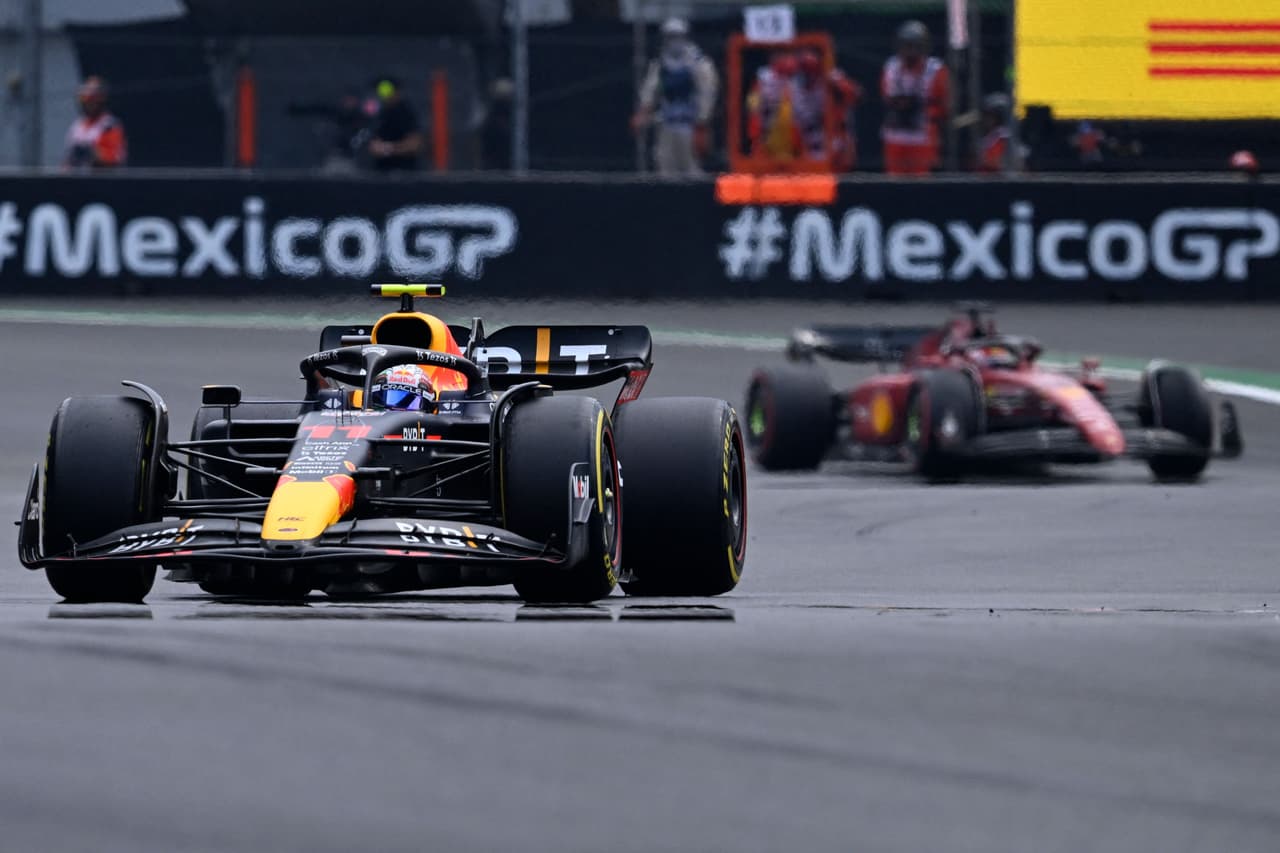 Red Bull Racing's Mexican driver Sergio Perez (L) races during the Formula One Mexico Grand Prix at the Hermanos Rodriguez racetrack in Mexico City on October 30, 2022. (Photo by Rodrigo ARANGUA / AFP) (Photo by RODRIGO ARANGUA/AFP via Getty Images)