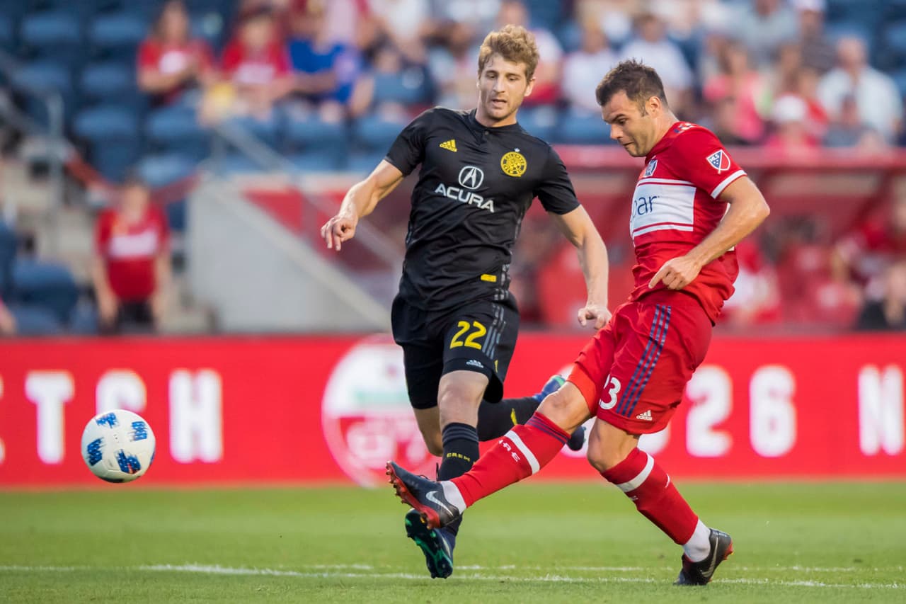 Aug 23, 2018; Chicago, IL, USA; Chicago Fire forward Nemanja Nikolic (23) scores against Columbus Crew defender Gaston Sauro (22) during the first half at Bridgeview Stadium. Mandatory Credit: Patrick Gorski-USA TODAY Sports