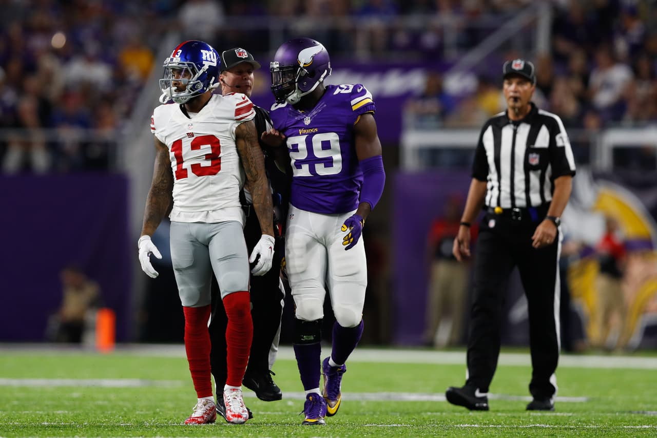 A game official gets between New York Giants wide receiver Odell Beckham Jr. (13) and Minnesota Vikings cornerback Xavier Rhodes (29) during an NFL football game on Monday, Oct. 3, 2016, in Minneapolis. Minnesota won 24-10. (Aaron M. Sprecher via AP)