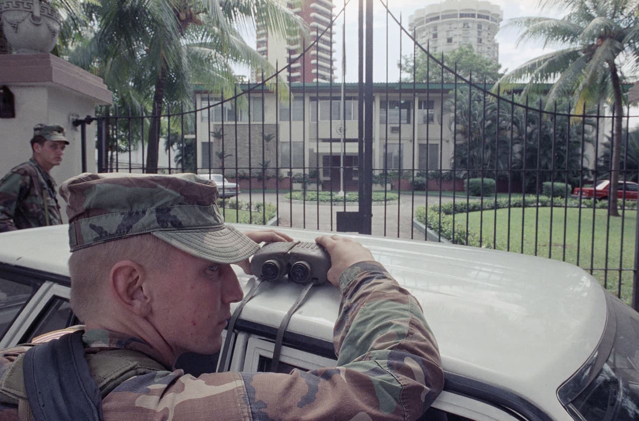 Lt. Daniel Barnett, of Willard, Ohio, mans the binoculars outside the front gate of the Vatican Embassy, Saturday, Jan. 7, 1989 in Panama City, where three days earlier strongman Manuel Noriega surrendered to U.S. authorities.