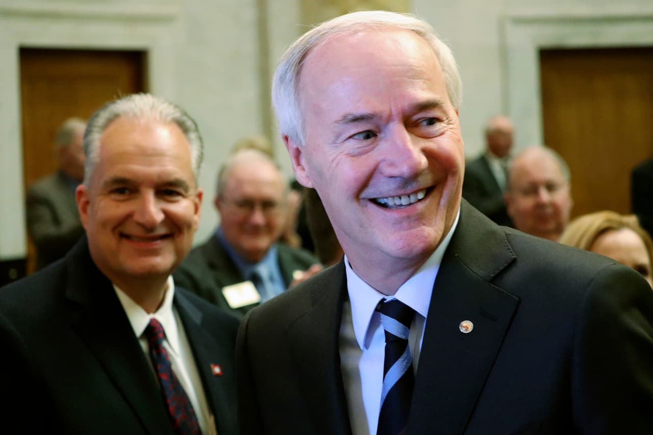 Gov. Asa Hutchinson prepares to speak to a joint session of legislators Monday, Feb. 12, 2018, at the state Capitol in Little Rock, Ark. Behind him is Arkansas Treasurer Dennis Milligan. The governor told lawmakers that, next year, he would like them to cut the state's top income tax rate from 6.9 percent to 6 percent, a move that would save Arkansas' top earners $180 million annually. (AP Photo/Kelly P. Kissel)