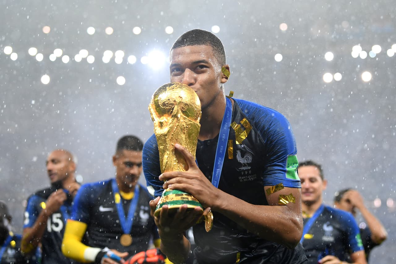 MOSCOW, RUSSIA - JULY 15: Kylian Mbappe of France celebrates with the World Cup trophy following the 2018 FIFA World Cup Final between France and Croatia at Luzhniki Stadium on July 15, 2018 in Moscow, Russia. (Photo by Matthias Hangst/Getty Images)