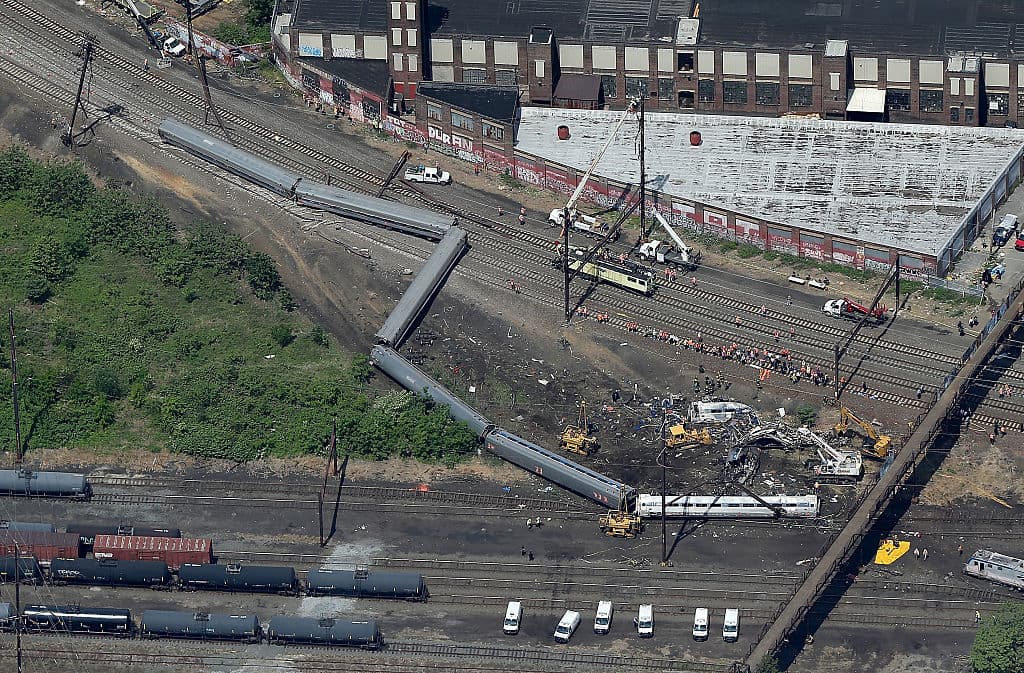 PHILADELPHIA, PA - MAY 13: Investigators and first responders work near the wreckage of Amtrak Northeast Regional Train 188, from Washington to New York, that derailed late last night May 13, 2015 in north Philadelphia, Pennsylvania. At least six people were killed and more than 200 others were injured in the crash. (Photo by Win McNamee/Getty Images)