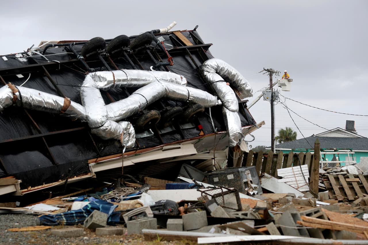 Power company lineman work to restore power after a tornado hit Emerald Isle N.C. as Hurricane Dorian moved up the East coast on Thursday, Sept. 5, 2018. (AP Photo/Tom Copeland)