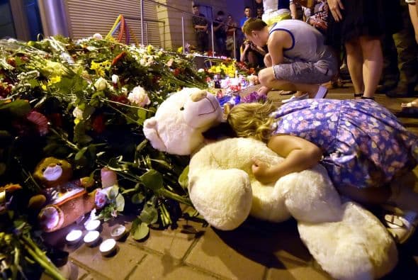 Personas dejan ramos de flores en conmemoración de las víctimas del avión estrellado de Malaysia Airlines al este de Ucrania frente de la embajada de Holanda en Kiev.