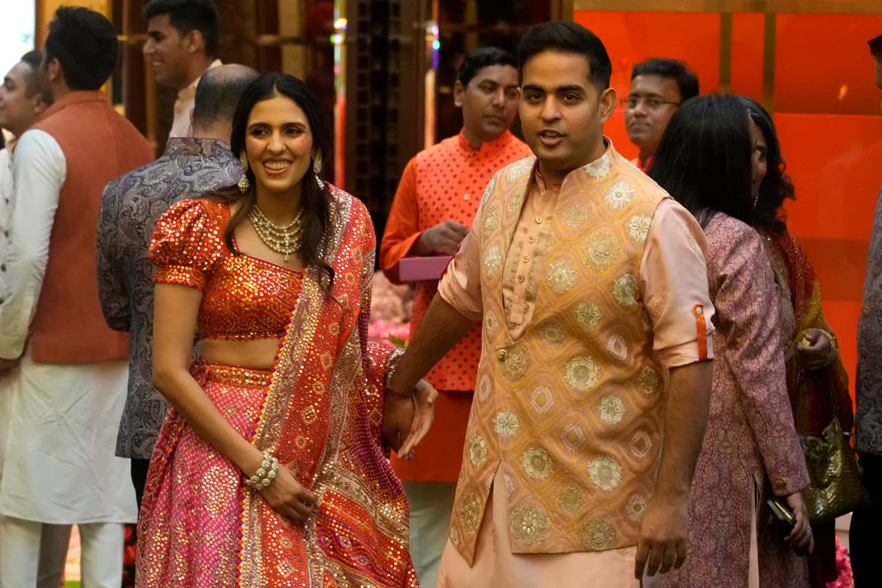 Akash Ambani, hijo de Mukesh Ambani, a la izquierda, junto con su esposa Shloka Mehta.