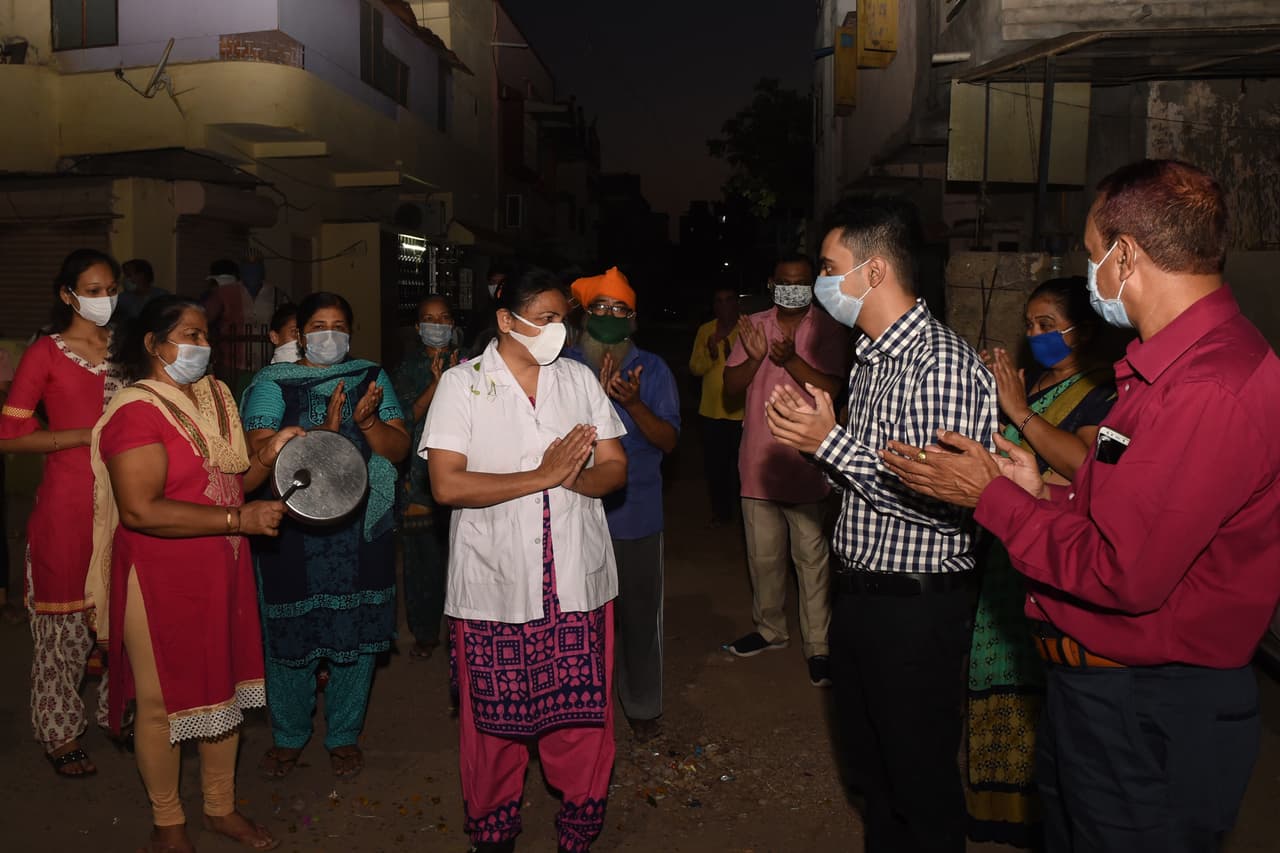 Residentes de Ahmedabad, India, saludan el Día Internacional de la Enfermera a la jefa del departamento de enfermería encargada de la atención de los pacientes con covid-19, en un hospital de la ciudad.