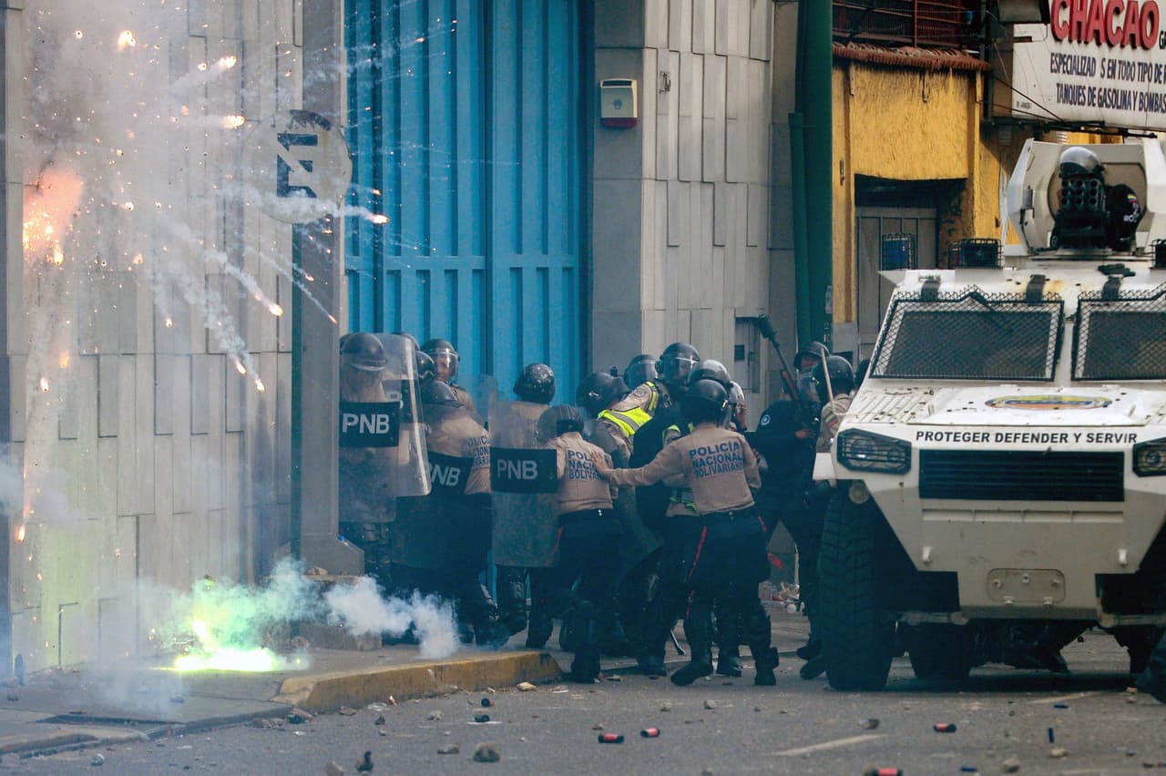 A group of police officers are attacked with fireworks by demonstrators. April 19, 2017.