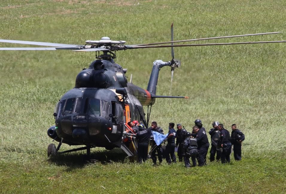 A helicopter evacuates a wounded officer