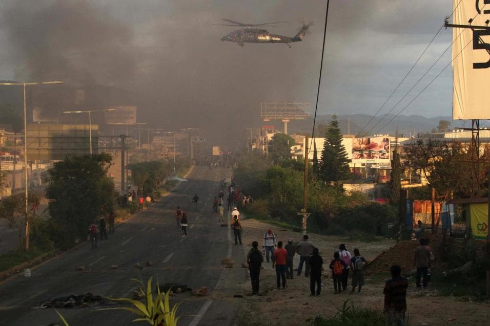 A police helicopter flies over Oaxaca protestors