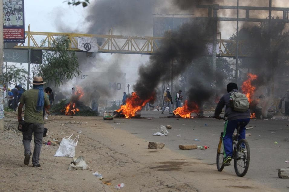 Protestors burn tires to block a federal highway in the state of Oaxaca