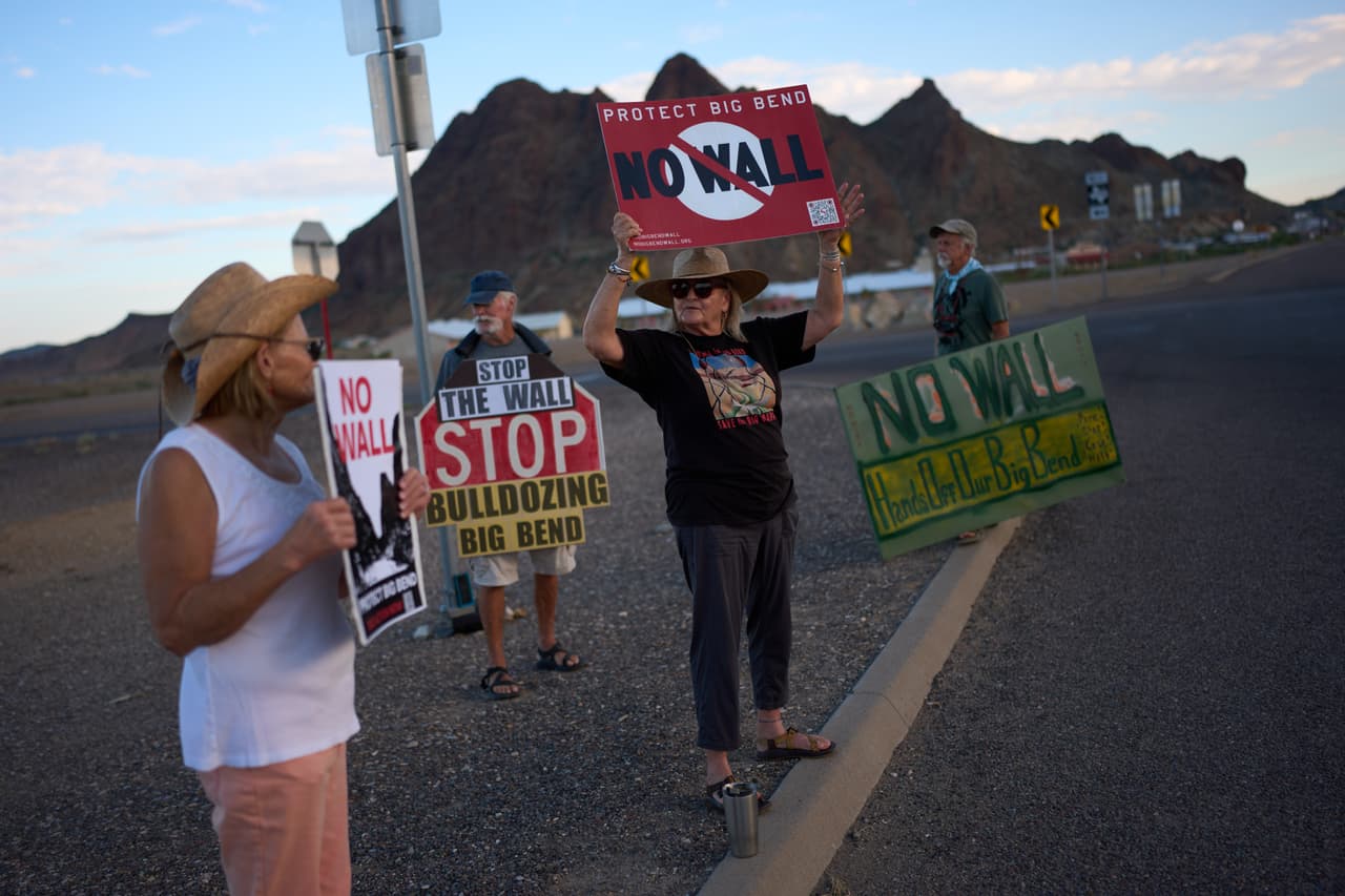 Pamela Priddy, en el centro, sostiene pancartas junto con otras personas durante una protesta semanal contra las barreras fronterizas en la región de Big Bend, el sábado 26 de septiembre de 2026, en Study Butte, Texas.