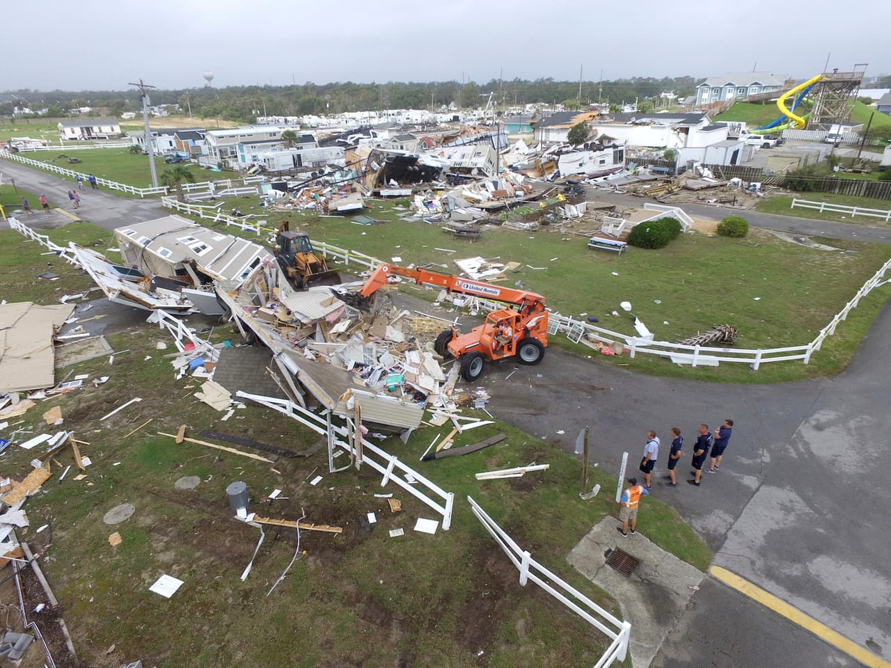Emerald Isle town employees work to clear the road after a tornado hit Emerald Isle N.C. as Hurricane Dorian moves up the East coast on Thursday, Sept. 5, 2018. (AP Photo/Tom Copeland)