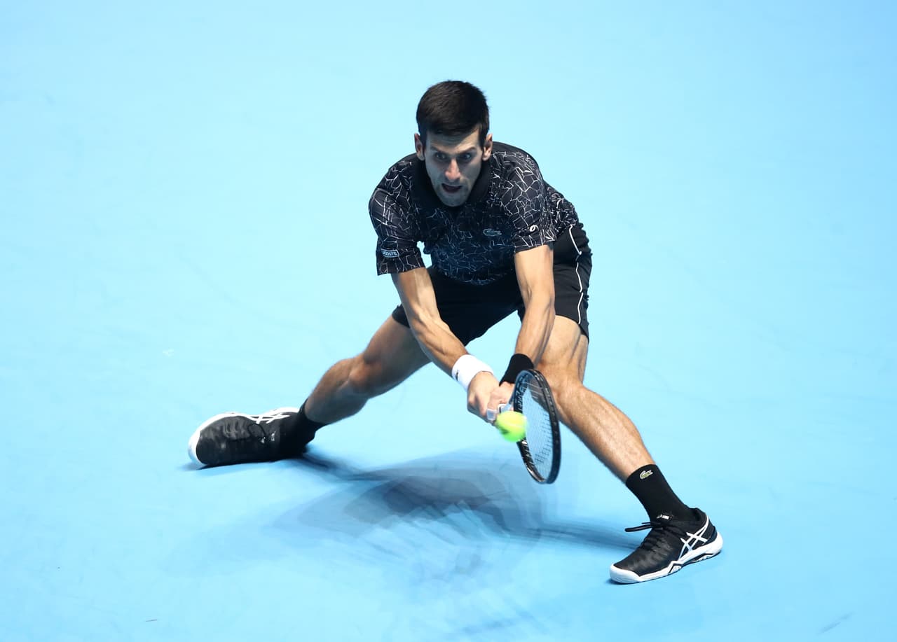 LONDON, ENGLAND - NOVEMBER 14: Novak Djokovic of Serbia plays a backhand during his singles round robin match against Alexander Zverev of Germany during Day Four of the Nitto ATP Finals at The O2 Arena on November 14, 2018 in London, England. (Photo by Julian Finney/Getty Images)