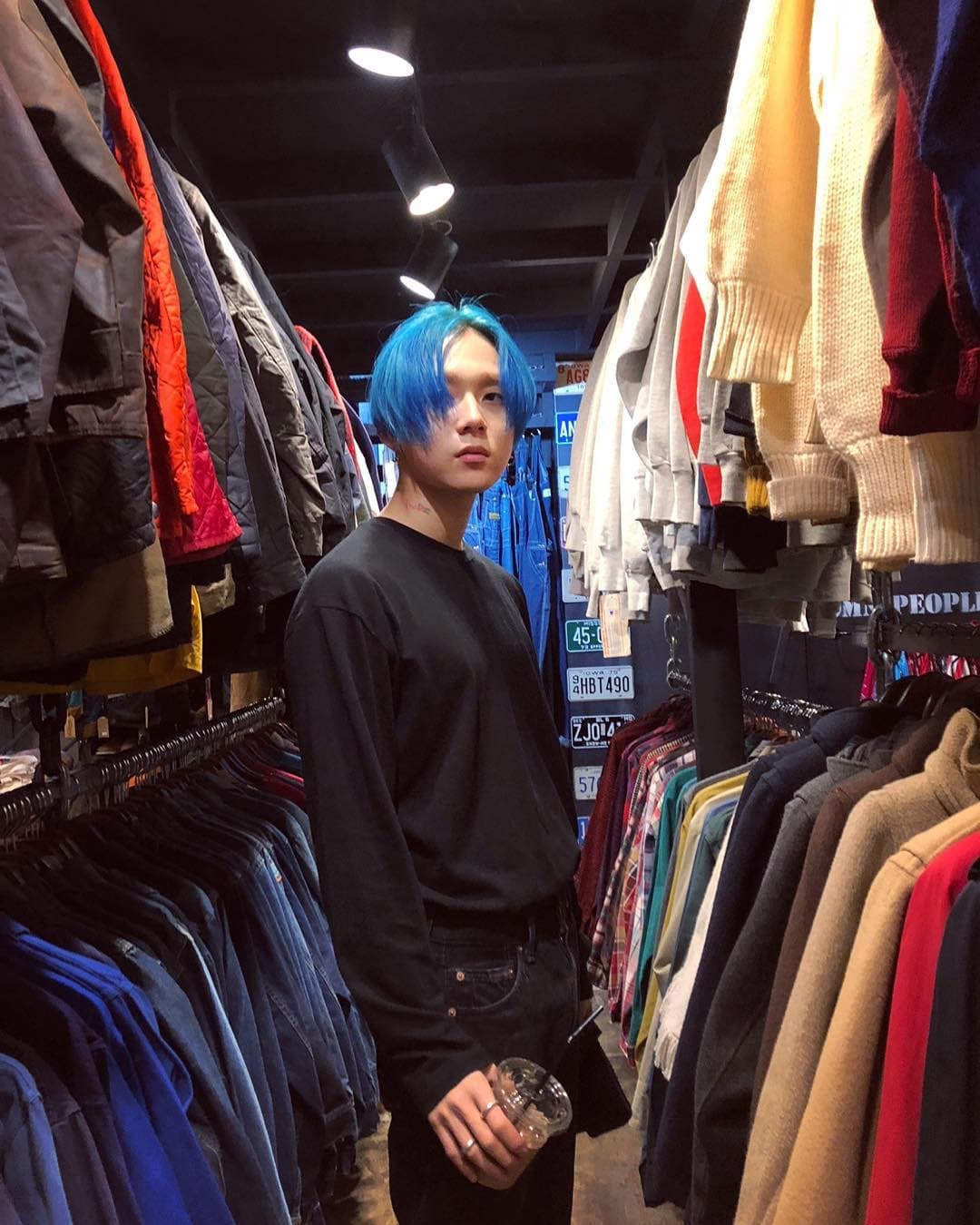 Kim Hyo-jong, conocido como E'Dawn, es un rapero y compositor coreano de canciones como "Kiss Kiss".En esta imagen muestra un cabellos azul, mismo que utilizó durante pocos días pero que combinó con su atuendo para que resaltara.