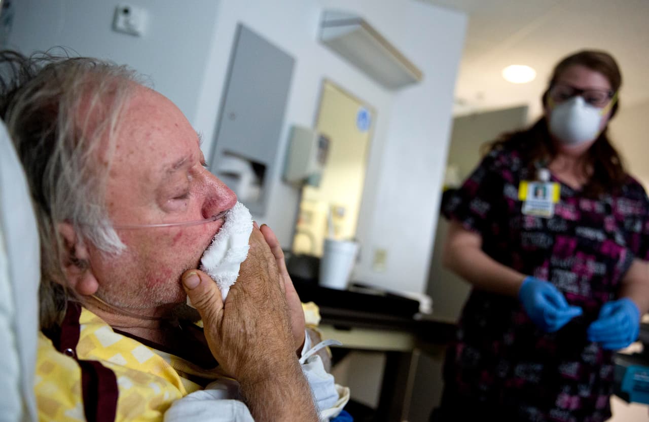 Henry Beverly, 73, battles the flu while tended to by nurse Kathleen Burks at Upson Regional Medical Center in Thomaston, Ga., Friday, Feb. 9, 2018. "I believe if I stand up right now I'd just collapse," said Beverly after days of battling the flu. Beverly came to the emergency room earlier in the week and was scheduled to go home after being treated before his symptoms took a quick turn for the worse. "I felt like my body was just going to blow up. A lot of people don't realize what the flu really is. It takes a lot to put me on my feet. I believe I would have died if I went home." (AP Photo/David Goldman)