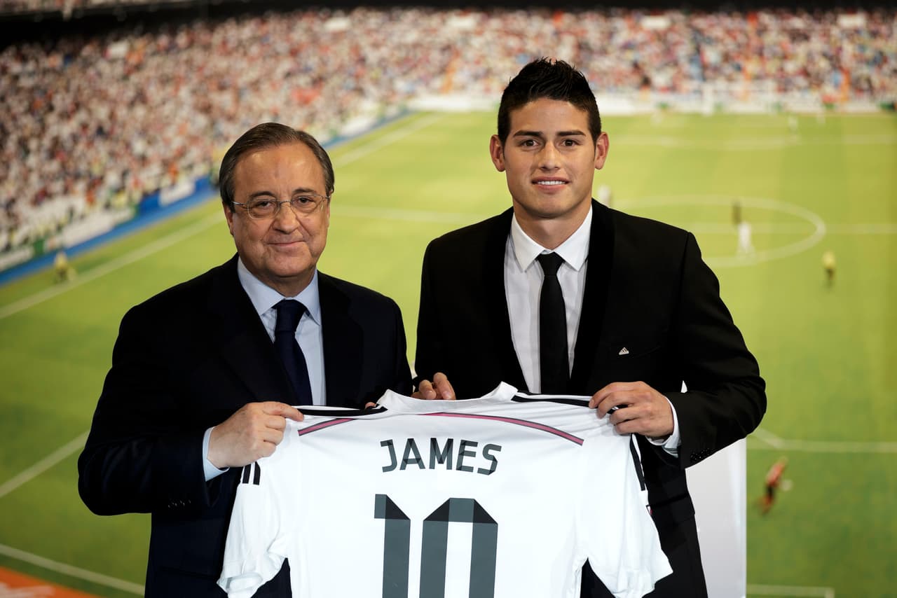 Real Madrid president Florentino Perez, left, and new Real Madrid player James Rodriguez, from Colombia, hold his new shirt and poses for photographers during his official presentation at the Santiago Bernabeu stadium in Madrid, Spain, Tuesday, July 22, 2014, after signing for Real Madrid. Real Madrid have signed Rodriguez from Monaco on a six-year contract. (AP Photo/Daniel Ochoa de Olza)