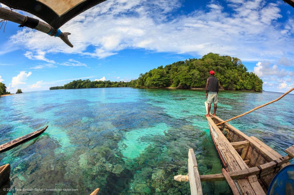 These places depend on local participation in environmental management, as well as deepwater shelters and good fishing and tourism practices. Here, a villager navigates the corals with a traditional Melanesian boat in his native island Mbuke, Papua New Guinea.