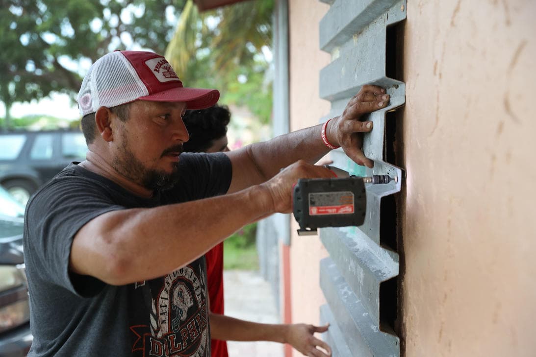 A Homestead resident in South Florida putting up hurricane shutters.