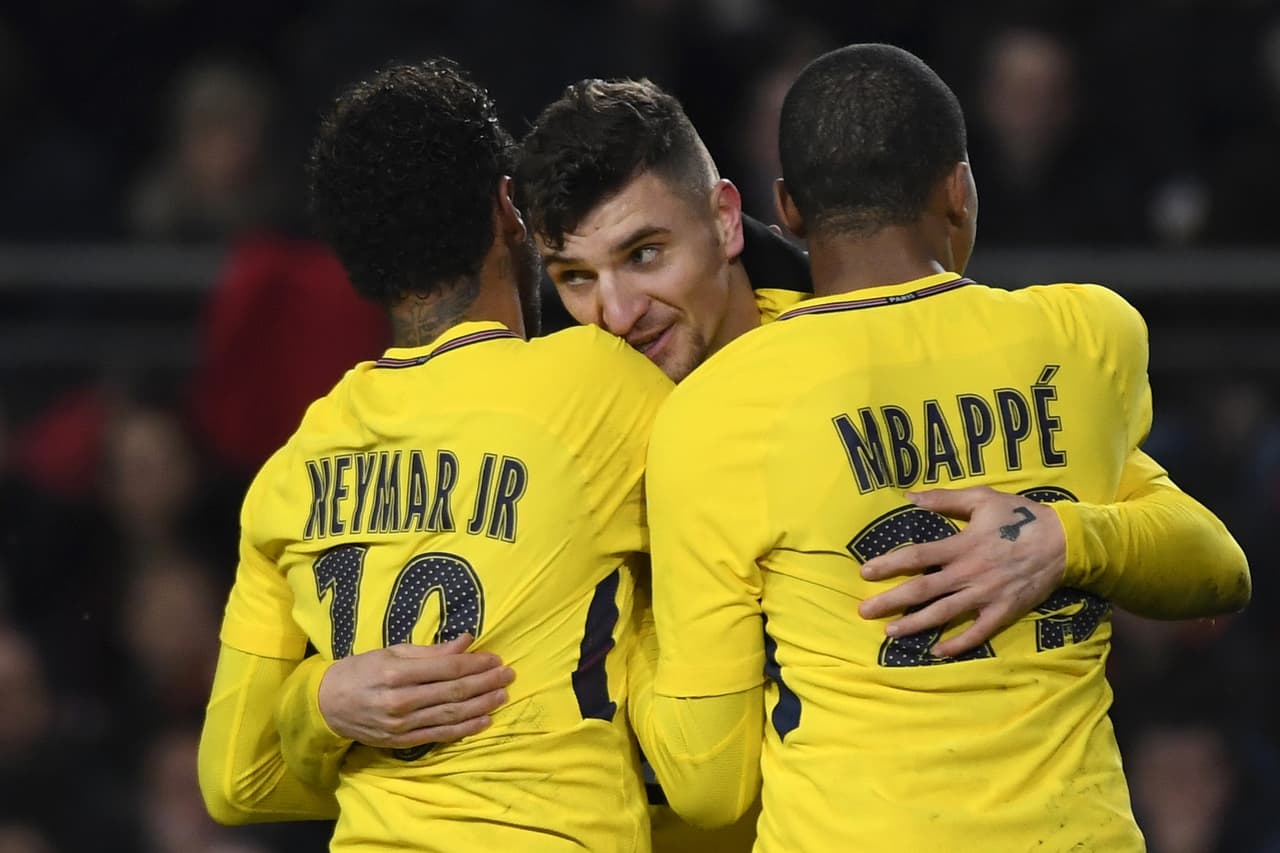 Paris Saint-Germain's Belgian defender Thomas Meunier (C) celebrates with Paris Saint-Germain's Brazilian forward Neymar (L) and Paris Saint-Germain's French forward Kylian Mbappe (R) after scoring a goal during the French League Cup football semi-final match between Rennes and Paris Saint-Germain at the Roazhon Park stadium in Rennes on January 30, 2018. / AFP PHOTO / DAMIEN MEYER (Photo credit should read DAMIEN MEYER/AFP/Getty Images)