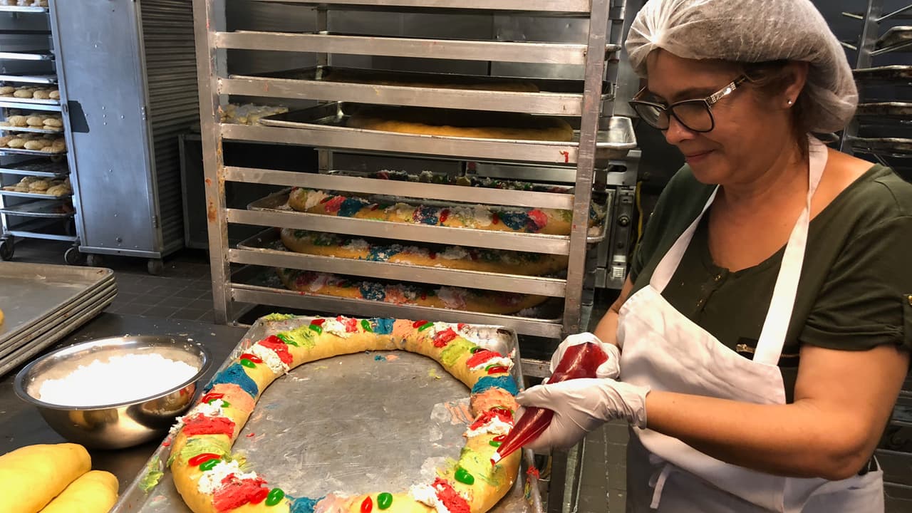 Una de las trabajadoras de la panadería de la familia Franco decora una de las roscas para entregar.