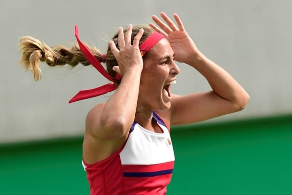 Monica Puig celebra su triunfo frente a Petra Kvitova