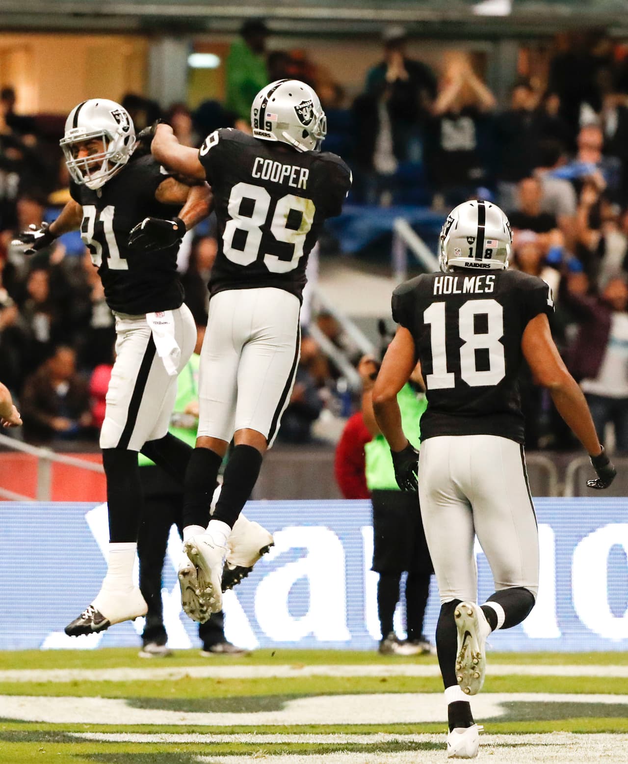 Oakland Raiders wide receiver Amari Cooper, center, celebrates his touchdown with teammates during the second half of an NFL football game against the Houston Texans Monday, Nov. 21, 2016, in Mexico City. (AP Photo/Eduardo Verdugo)