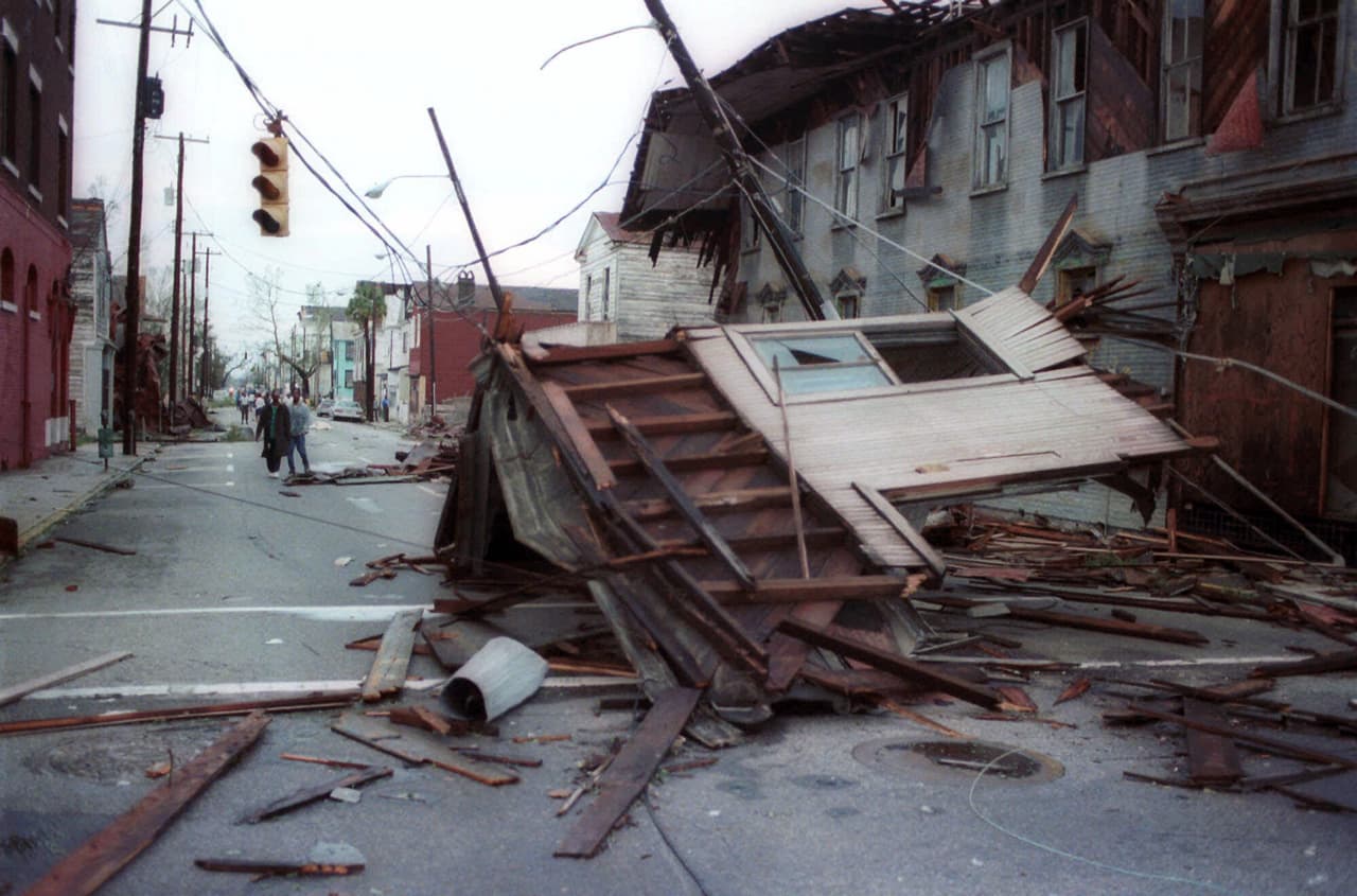 FILE - In this Sept. 22, 1989 file photo, parts of buildings clutter the streets of Charleston, S.C. after Hurricane Hugo swept through the city. Twenty five years after the storm, Charleston Mayor Joseph P. Riley Jr., the longest-serving mayor in Charleston history, says preparing for and recovering from the storm was the most important time in his service to the city. Sunday, Sept. 21, 2014 is the 25th anniversary of Hugo's landfall. (AP Photo/Lou Krasky, File)